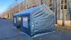 Two blue tarps covering outdoor furniture on a patio