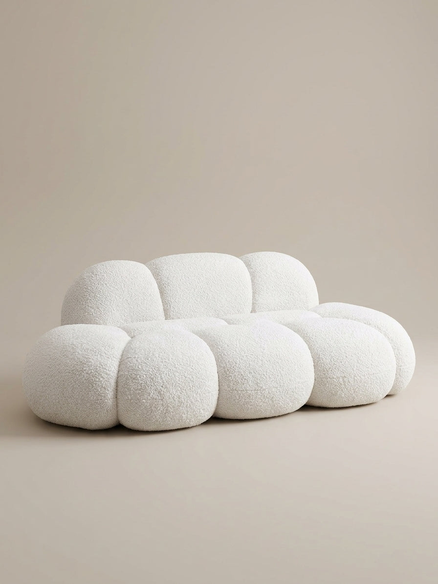 Cream cloud-shape boucle sofa, 3-seater, front side view on a neutral background