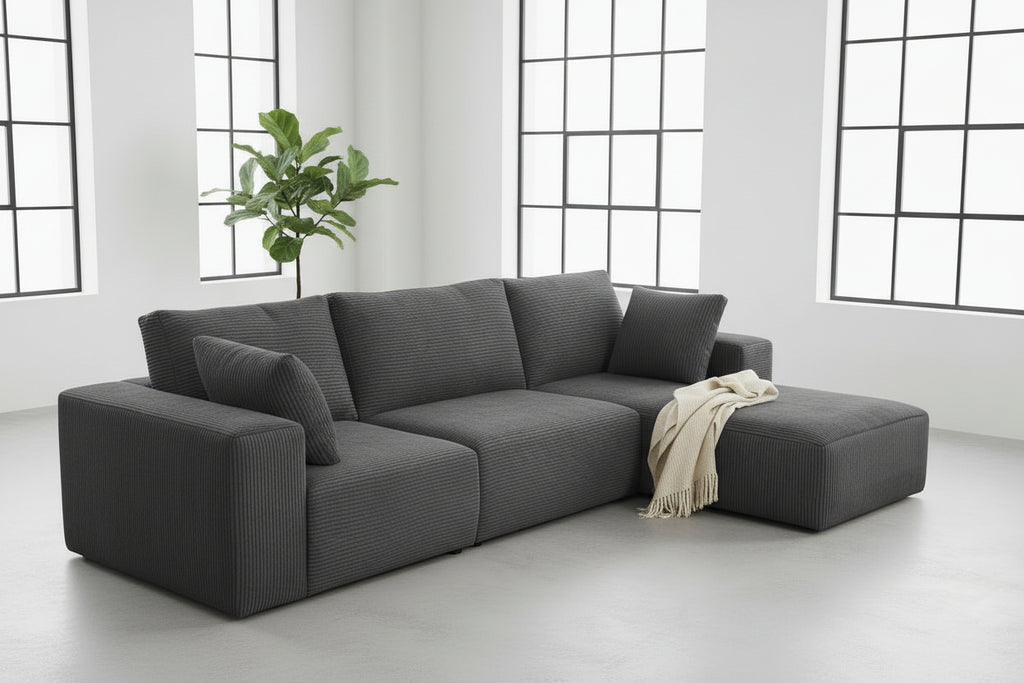 Gray sectional sofa in a living room setting with decor elements.