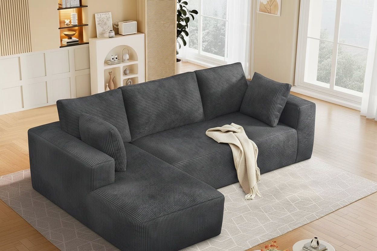 Gray sectional sofa in a living room setting with decor elements.