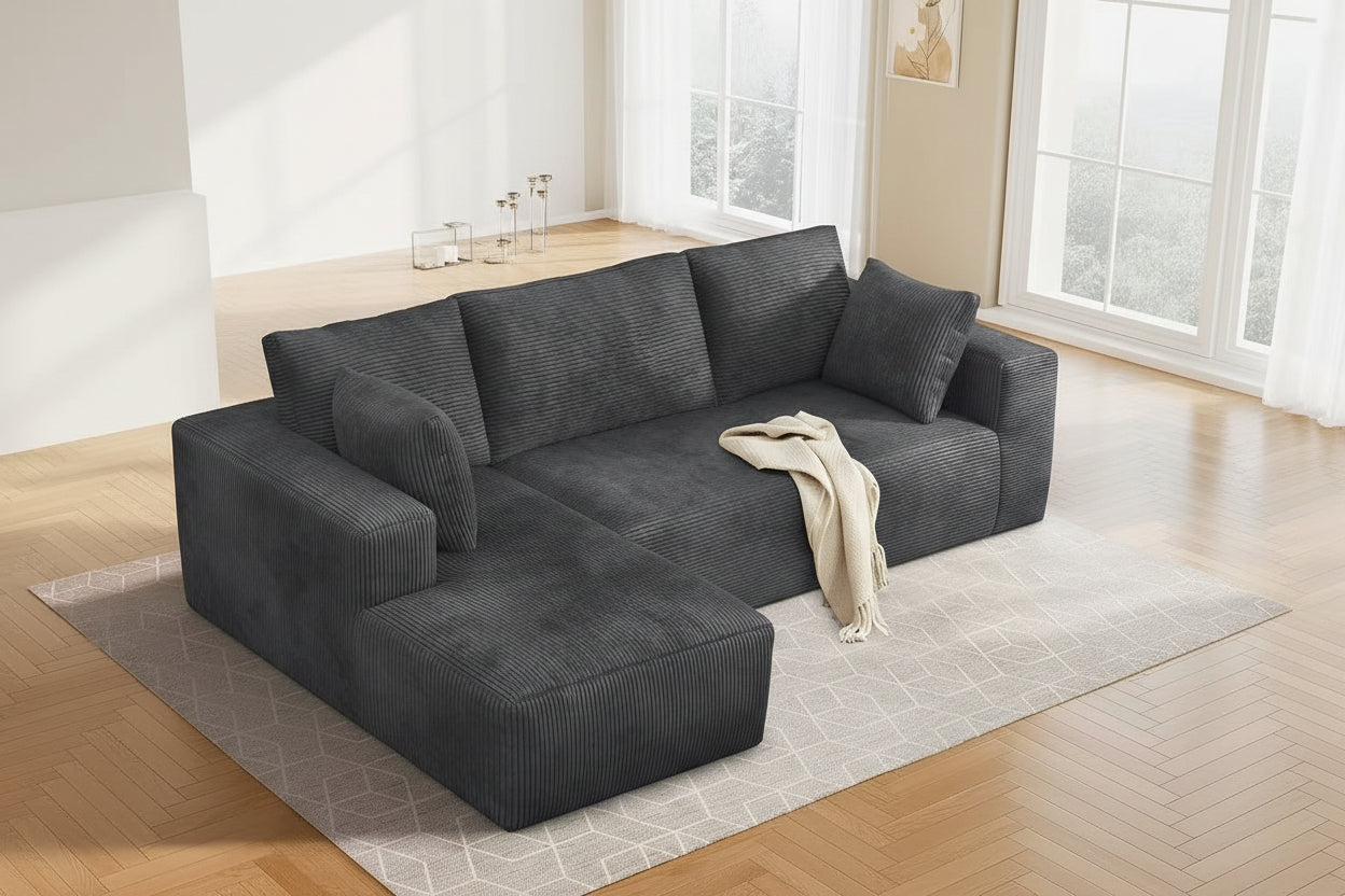 Gray sectional sofa in a living room setting with decor elements.