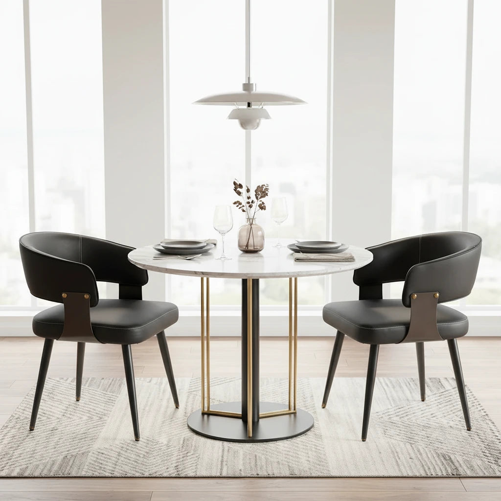 Dining room with a round table and black chairs, featuring a modern light fixture and abstract art on the wall.