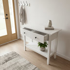 White console table with beige top on a dark floor.