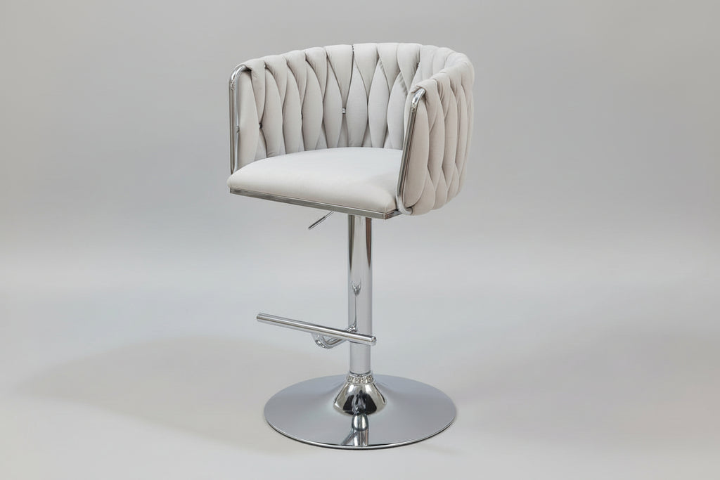 Tufted bar stool with chrome base on a tiled floor