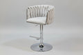 Tufted bar stool with chrome base on a tiled floor