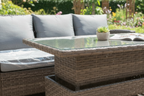 Outdoor patio furniture set with a table and chairs on a wooden deck.