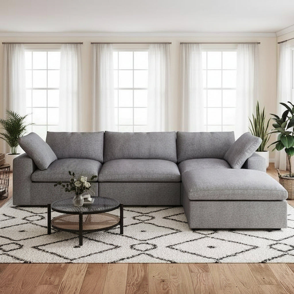 Gray sectional sofa in a living room with a coffee table and decor items.