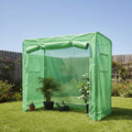 Green garden shelter in a backyard with plants and a wooden fence.